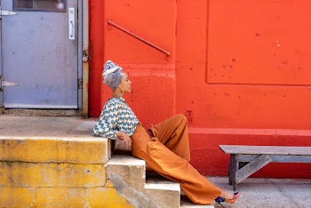 Woman Sitting on Concrete Staircase