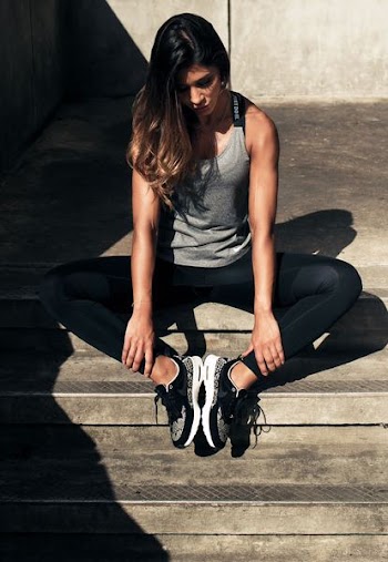 woman sitting on concrete stairs during daytime
