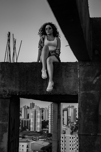Woman Sitting on Concrete Structure