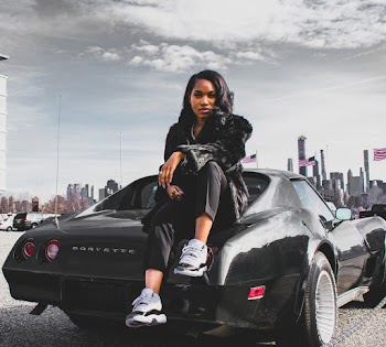 Woman Sitting on Corvette