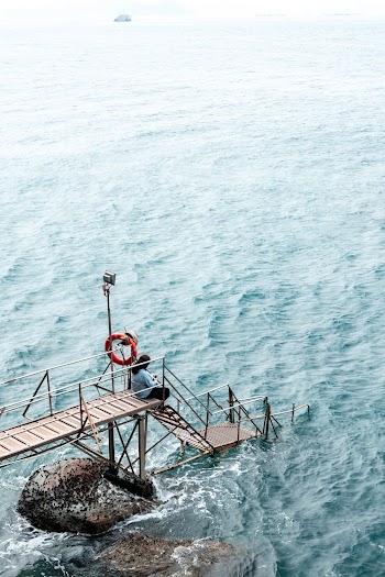 Woman Sitting on Dock