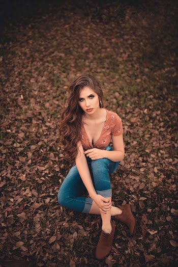 Woman Sitting on Dried Leaves