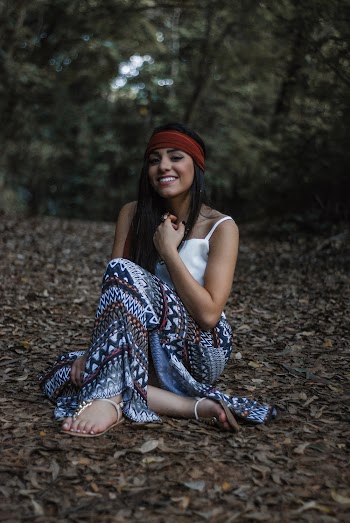 Woman Sitting On Dry Leaves