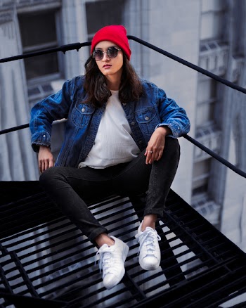Woman Sitting on Emergency Fire Exit Platform