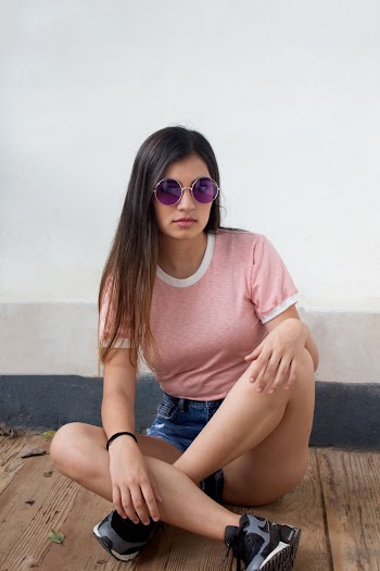 Woman Sitting on Floor Beside Wall