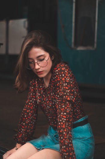Woman Sitting on Floor While Looking Down