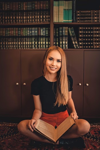Woman Sitting on Floor With Book on Lap