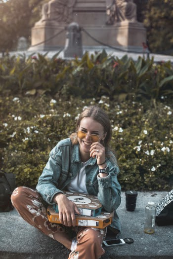 Woman Sitting on Floor With Boxes on Lap