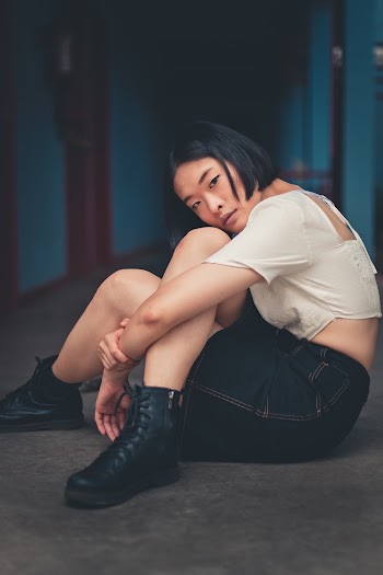 Woman Sitting On Floor With Legs Cross