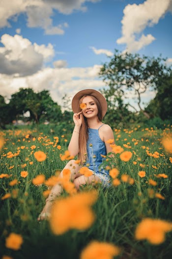 Woman Sitting on Flower Field