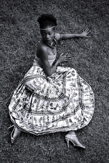 Woman Sitting On Grass Field