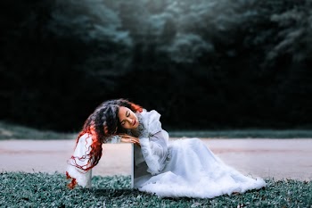 Woman Sitting on Grass Field