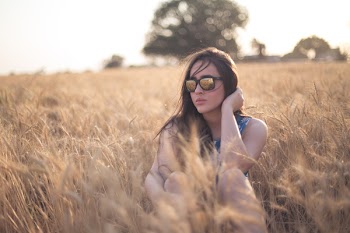 Woman Sitting on Grass Field