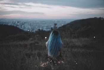 Woman Sitting on Grass Field