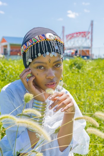 Woman Sitting On Grass Field