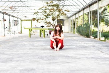 woman sitting on gray concrete surface posing for photo