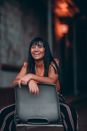 Woman Sitting on Gray Plastic Chair