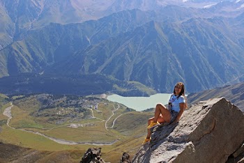 Woman Sitting on Gray Stone