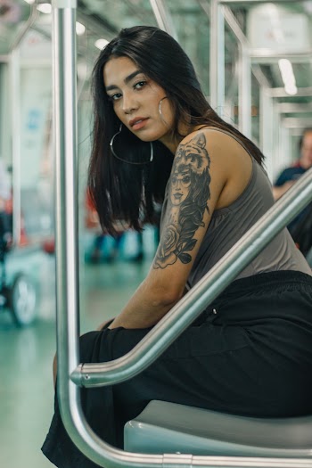 Woman Sitting on Gray Train Seat