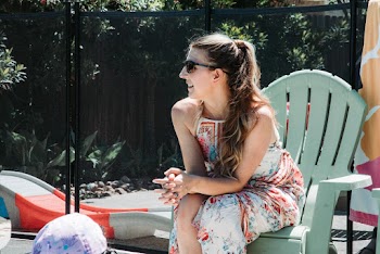 Woman Sitting on Green Adirondack Chair