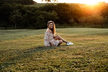 Woman Sitting on Green Grass Field