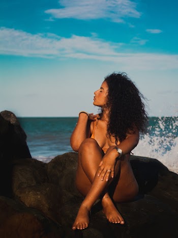Woman Sitting on Grey Rock