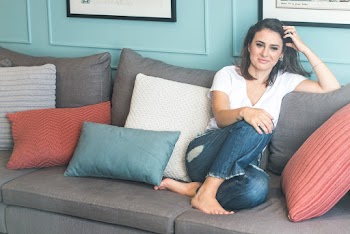 Woman Sitting on grey Sofa