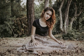 Woman Sitting on Ground in Black T-shirt