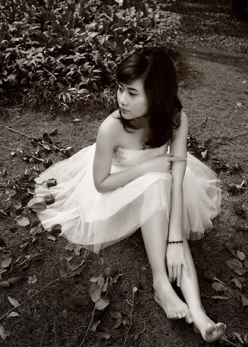 Woman Sitting on Ground Near Plants