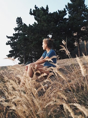 Woman Sitting on Ground Near Trees