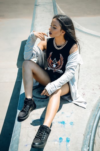 Woman Sitting on Ground Posing