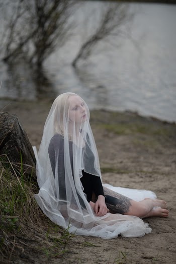 Woman Sitting on Ground While Wearing White Veil