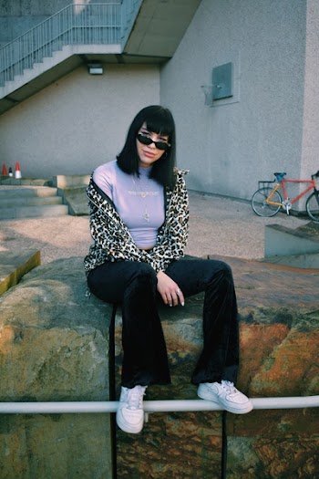 Woman Sitting on Ledge