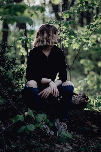 Woman Sitting On Log
