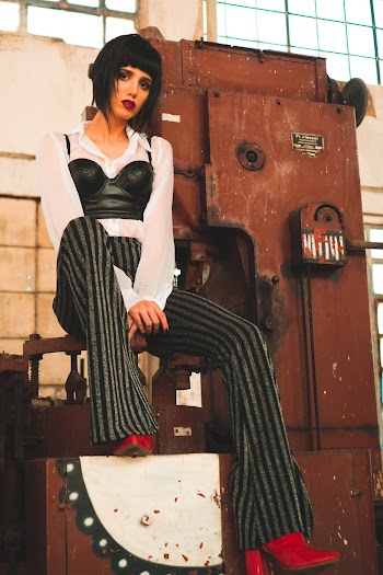 Woman Sitting on Machinery