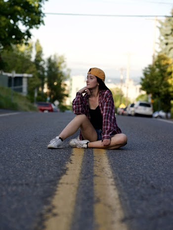 Woman Sitting On Middle Of The Road