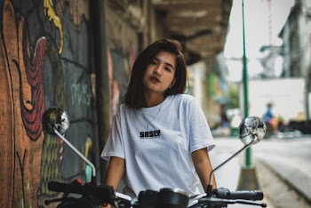 Woman Sitting on Motorcycle Parked Beside the Road