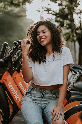 Woman Sitting on Orange BIkes