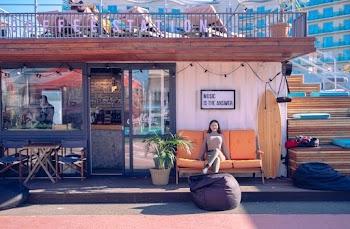 Woman Sitting on Orange Couch