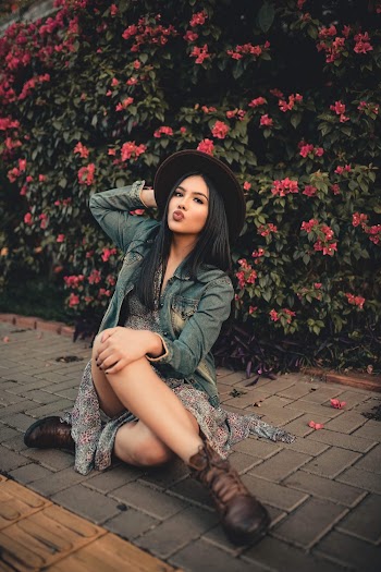 Woman Sitting on Pavement