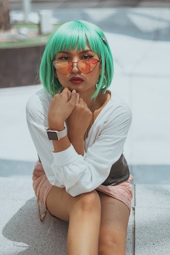 Woman Sitting on Pavement