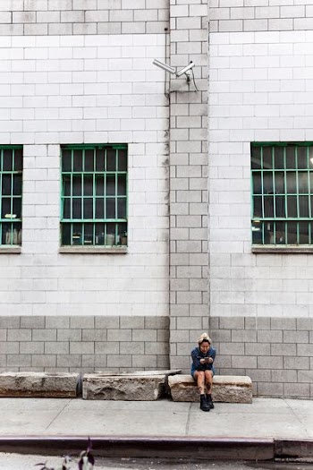 woman sitting on pavement