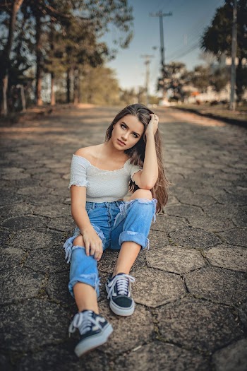 Woman Sitting on Pavement