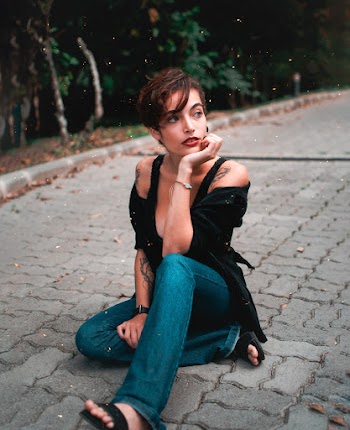 Woman Sitting on Pavement E