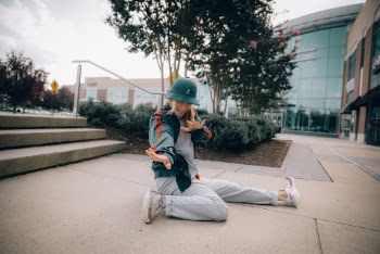 Woman Sitting on Pavement Near Outdoor