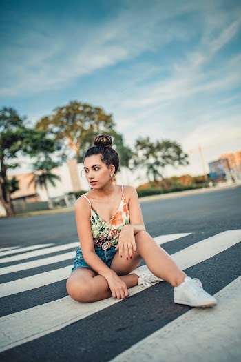 Woman Sitting on Pedestrian Crosswalk