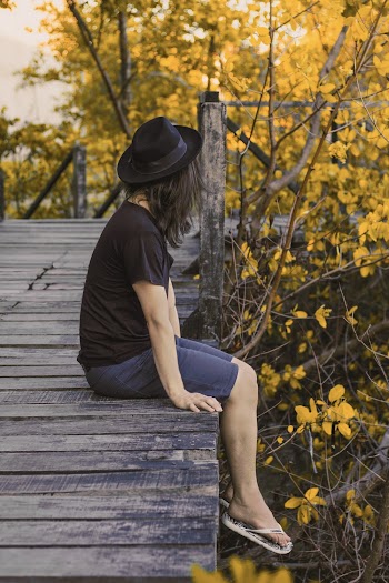 Woman Sitting on Port Beside Trees