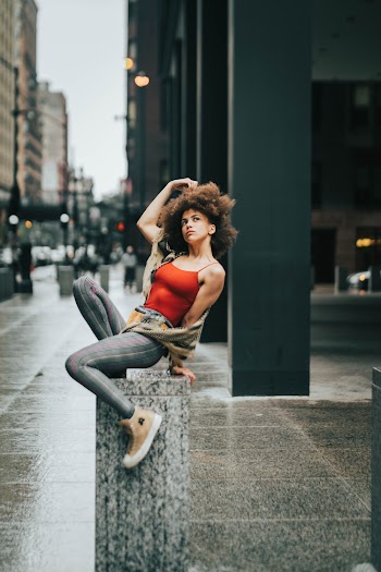 Woman Sitting on Post