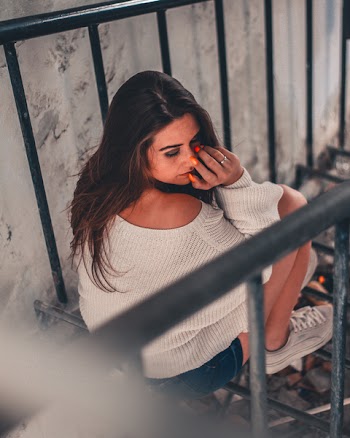 Woman Sitting on Rail