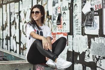 Woman Sitting On Rail While Smiling